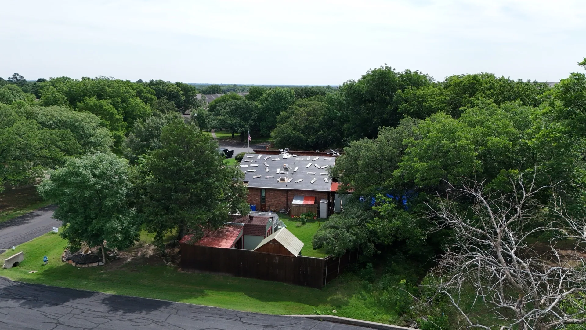 Aerial drone photograph of a Corinth, Texas home with a roof replacement in progress, used as the hero image for Frame Restoration's Corinth service area