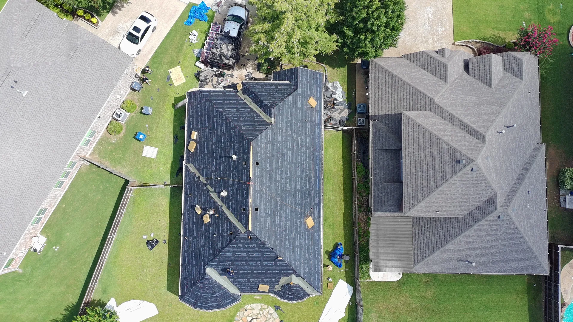 Top-down drone photo of a McKinney home with synthetic underlayment installed across the roof planes during a Frame Restoration roof replacement
