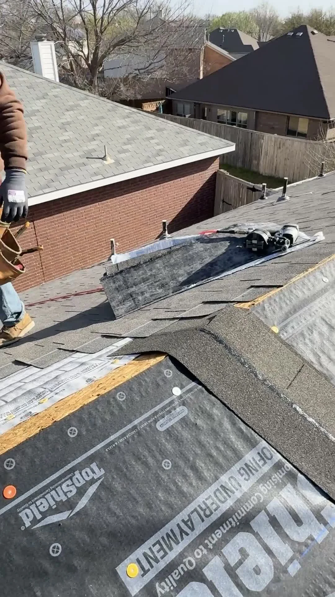 McKinney roof repair detail showing underlayment, replacement shingles, and fasteners during in-progress roof work by Frame Restoration